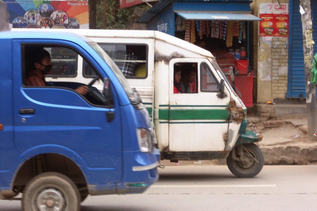 Female "Tempo" driver navigates traffic in Kathmandu